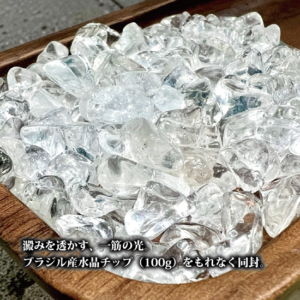 木製の器に山盛りにされた、氷のように透き通るブラジル産水晶のチップ。一粒一粒が光を反射し、澱みのない清らかなエネルギーを放っている。
